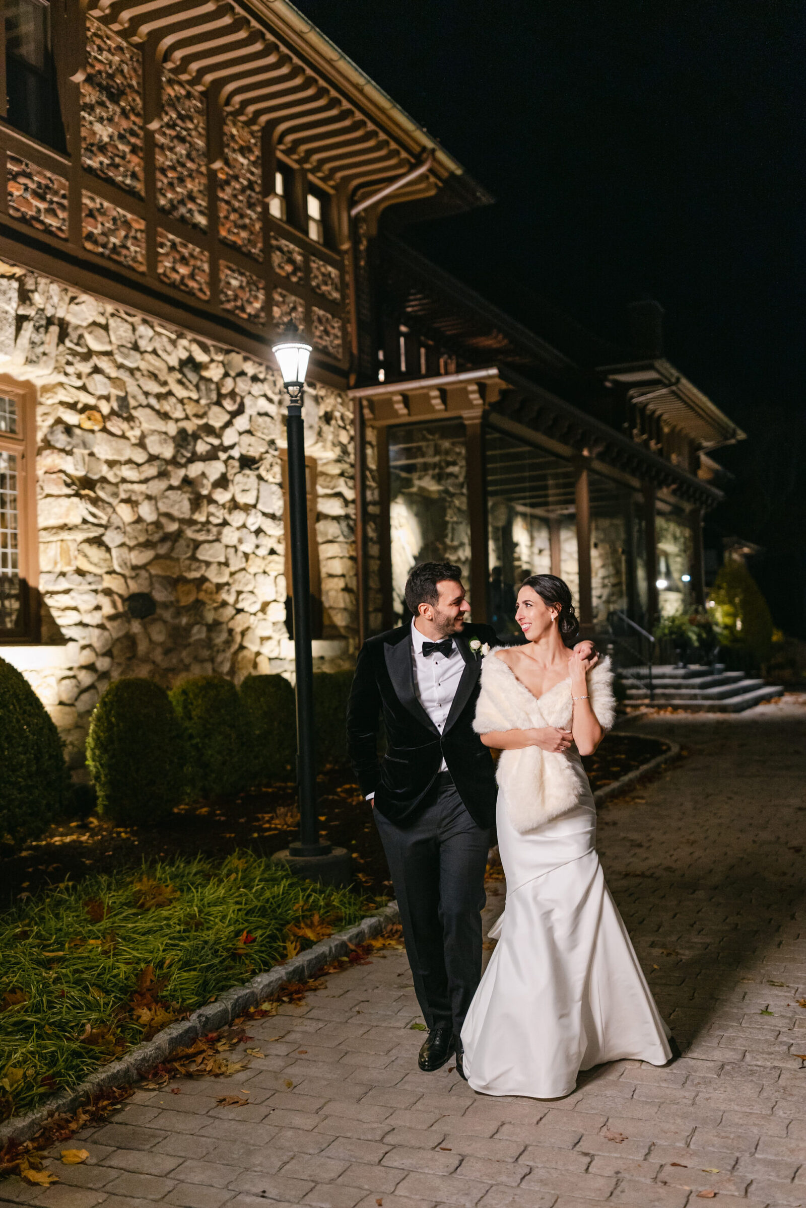 Bride and groom outside at night at Le Chateau wedding